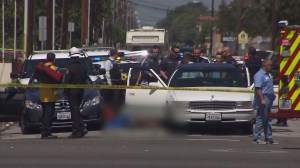 Two people were dead after a car-to-car shooting that prompted a police officer to open fire in Hawthorne on April 1, 2015. (Credit: KTLA)