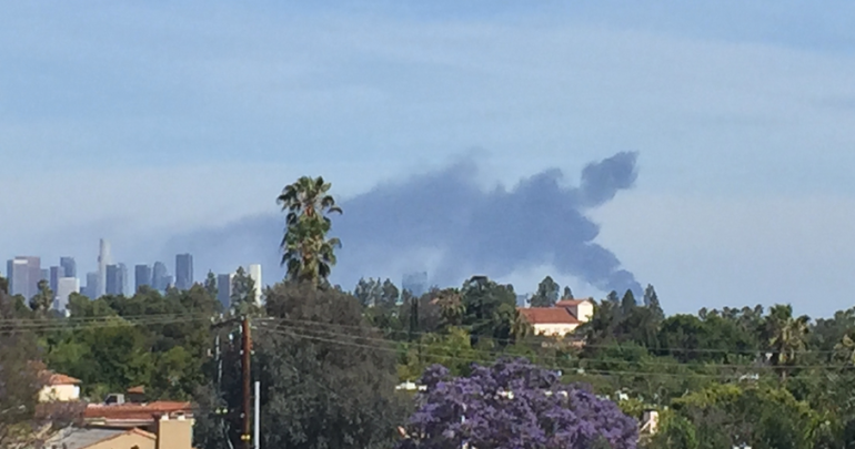 Dark plumes of smoke could be seen coming from a fire on the 710 Freeway in Bell on April 26, 2016. (Credit: Christina Fawaz/KTLA)