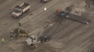 The big rig remained in the middle of the freeway hours after the deadly crash on the 57 in Fullerton. (Credit: KTLA) 