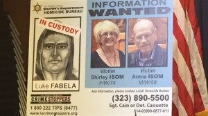 A poster displayed at a sheriff's news conference May 6, 2015, indicated a suspect was in custody in the killings of Troy and Shirley Isom. (Credit: Kareen Wynter / KTLA)