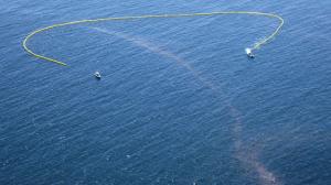 An oil boom is deployed offshore as the cleanup and containment effort continues along in Santa Barbara County. (Credit: Brian van der Brug / Los Angeles Times)