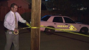 Investigators are seen in Adelanto on June 11, 2015, after a 7-year-old boy was shot and killed. (Credit: KTLA)