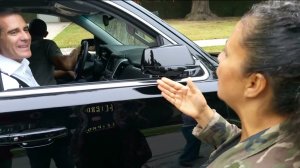 A protester speaks with Los Angeles Mayor Eric Garcetti outside his home in Windsor Square on Monday, June 9, 2015. (Credit: KTLA)