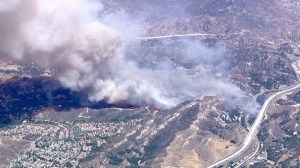 Smoke towers over a brush fire that threatened homes in Santa Clarita on June 24, 2015. (Credit: KTLA)