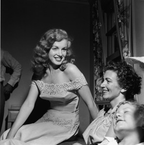 Marilyn Monroe, left, presents the winner of a "dream house" contest from Photoplay Magazine with the key to a new house in Warrenburg, New York, in June 1949. (Credit: Hulton Archive/Getty Images)