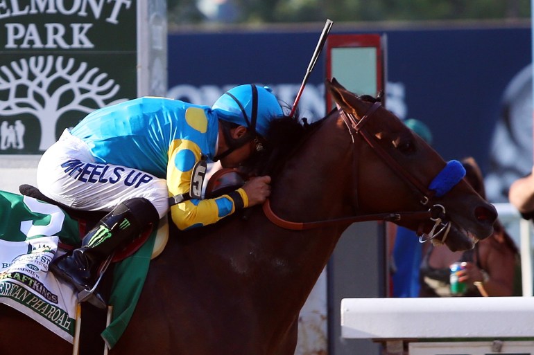 Victor Espinoza, celebrates atop American Pharoah #5, after winning the 147th running of the Belmont Stakes at Belmont Park on June 6, 2015, in Elmont, New York.  (Credit: Travis Lindquist/Getty Images)