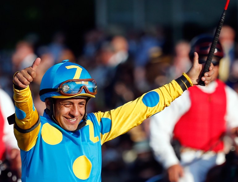 Victor Espinoza, celebrates atop American Pharoah #5, after winning the 147th running of the Belmont Stakes at Belmont Park on June 6, 2015, in Elmont, New York. (Credit: Rob Carr/Getty Images)