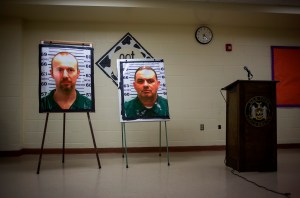 Pictures of escaped prisoners Richard Matt and David Sweat are displayed at a press conference in Saranac, New York, on Friday, June 12, 2015. (Credit: Eric Thayer/Getty Images)