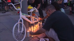 A ghost bike is placed near the spot where cyclist Jose Luna was killed by a hit-and-run driver on June 26, 2015. (Credit: KTLA)