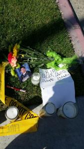 A photo from a KTLA viewer shows candles and a photo left June 24, 2015, at the scene where Oscar Lazo died.