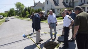 New York Gov. Andrew Cuomo looks at the manhole two convicted murderers allegedly climbed through to escape a maximum security prison. Guards realized they were missing on June 6, 2015. 