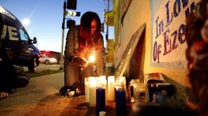 Tritobia Ford, mother of Ezell Ford, lights candles at her slain son's memorial at 65th Street and Broadway after the LAPD released Ezell Ford's autopsy results in December 2014. (Credit: Marcus Yam / Los Angeles Times)