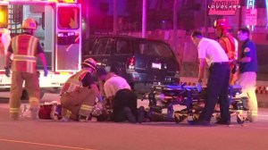 Officials are seen performing CPR on Makeda More who was struck and killed by a hit-and-run driver in Bellflower on July 25, 2015. (Credit: Loudlabs)