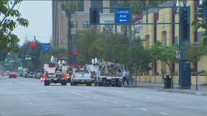 Utility crews are seen in downtown Long Beach, where power outages continued on Friday, July 17, 2015. (Credit: KTLA)
