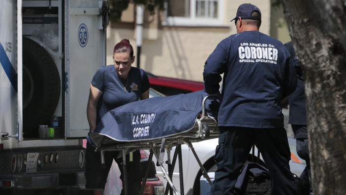 Los Angeles County Sheriff's Department homicide detectives and officials from the coroner's office remove human remains from an apartment in the Harbor Hills Housing Project in the Lomita area on July 2, 2015. (Credit: Mark Boster / Los Angeles Times)