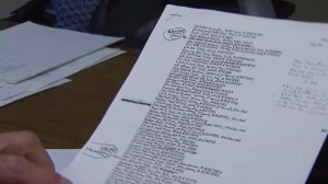 Attorney Robert Rentzer on July 23, 2015, holds a list he said was written by Jeffrey Lash itemizing his stolen guns. (Credit: KTLA)
