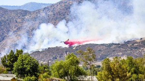 An aircraft drops fire retardant on the Mill 2 Fire near Yucaipa on Sunday, July 12, 2015. (Credit: Ashley K. Photography)