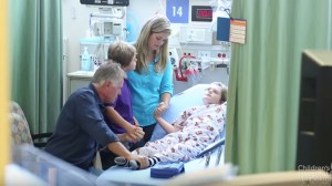 Max Page, right, is seen praying with his family before undergoing surgery to have a heart valve implanted. (Credit: Childrent's Hospital Los Angeles)