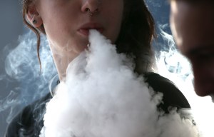 Rhiannon Griffith-Bowman smokes an e-cigarette at Digital Ciggz in San Rafael on Jan. 28, 2015, when the California Department of Public Health released a report calling e-cigarettes a health threat and suggesting that they should be regulated like regular cigarettes and tobacco products. (Credit: Justin Sullivan/Getty Images)