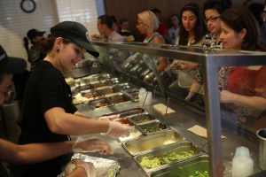 Chipotle restaurant workers fill orders on April 27, 2015, in Miami. (Credit: Joe Raedle/Getty Images)