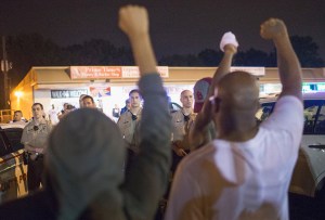 Demonstrators, marking the one-year anniversary of the shooting of Michael Brown, face off with police during a protest along West Florrisant Street on Aug. 9, 2015, in Ferguson, Missouri. (Credit: Scott Olson/Getty Images)