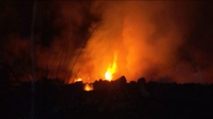 Flames are seen in a Montebello riverbed on Monday, Aug. 17, 2015. (Credit: KTLA)