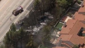 The fire burned between the 118 Freeway and a condo complex in Porter Ranch on Aug. 13, 2015. (Credit: KTLA)