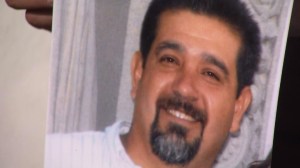 Rene Balbuena is shown in a photo held by a family member in October 2013. (Credit: KTLA)