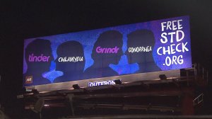 This billboard from AIDS Healthcare Foundation, posted near the West Hollywood headquarters of Tinder, is shown Sept. 28, 2015. (Credit: KTLA)