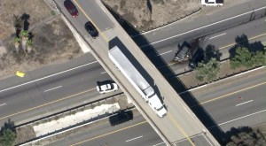 Two SUVs are left on the 215 Freeway after a crash, pursuit and fatal shooting on Sept. 18, 2015. (Credit: KTLA)