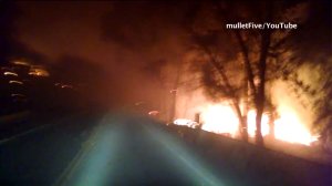 A screenshot from a driver's video shows massive flames burning in the Anderson Springs community of Lake County on Saturday, Sept. 12, 2015. (Credit: mulletFive/YouTube)