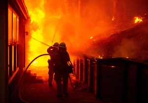 A house is engulfed in flames as firefighters attempt to put it out during the Valley Fire in Seigler Springs, California, on Sept.r 13, 2015. (Credit: Josh Edelson/AFP/Getty Images)