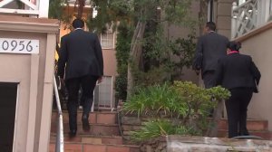 Investigators on Sept. 22, 2015, walk into a building where a woman was found dead after a fire near UCLA. (Credit: KTLA)
