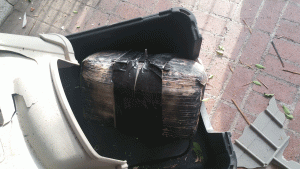The marijuana bundle crashed through the roof of a carport in the middle of the night and landed in an empty dog crate. (Credit: Nogales Police Department)