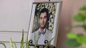 A photo of Shayan Mazroie is seen outside a Laguna Niguel home, where a vigil was held in his honor on Saturday, Sept. 12, 2015. (Credit: KTLA)