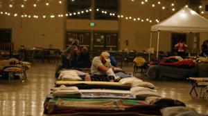 Dave Burns digs into a Red Cross toiletries bag before bedding down on a cot at the Napa County Fairgrounds evacuation center in Calistoga. The 50-year resident of Middletown said the Valley fire rolled over his family's truck and heavy equipment business. (Credit: Don Bartletti / Los Angeles Times)