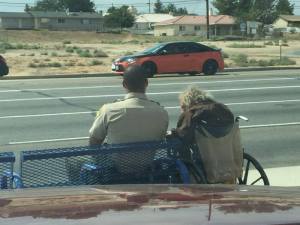 Deputy Nathan Sims sits next to a High Desert resident in Victorville on Sept. 10, 2015, in an image sent to the Sheriff's Department by a witness.