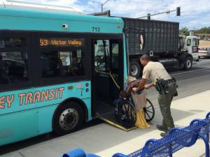 Deputy Nathan Sims helps a man onto a bus on Sept. 10, 2015, in an image sent to the Sheriff's Department by a witness.