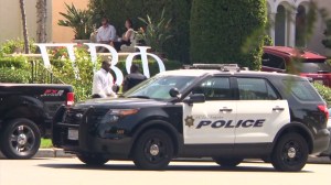 Investigators work outside an apartment complex where many Pi Beta Phi members live on Sept. 21, 2015, when a woman's body was found in a burning unit. (Credit: KTLA)