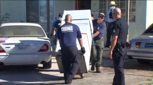 Los Angeles County coroner's officials removed a refrigerator containing a man's body from a home in Sun Valley on Sunday, Sept. 13, 2015. (Credit: KTLA)