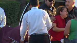 The wife of a young father struck and killed by a hit-and-run driver in Santa Ana arrives at the scene of the crash. (Credit: KTLA News)