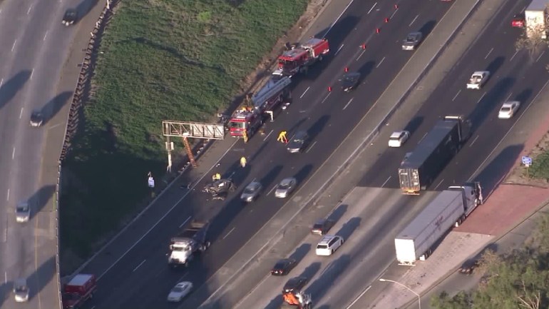 Los Angeles firefighters respond to a fatal crash along the 5 Freeway that left a man's body on an overhead exit sign on Oct. 30, 2015. (Credit: KTLA)