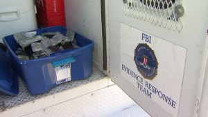 The FBI uncovered cash connected to a 2014 armored-car heist in the yard of a Fontana home on Oct. 7, 2015. (Credit: pool)