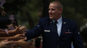 U.S. Air Force Airman First Class Spencer Stone shakes hands with the crowd during a parade honoring his Aug. 21, 2015, actions in overpowering a gunman on a Paris-bound train on Sept. 11, 2015, in Sacramento. (Credit: Stephen Lam/ Getty Images)