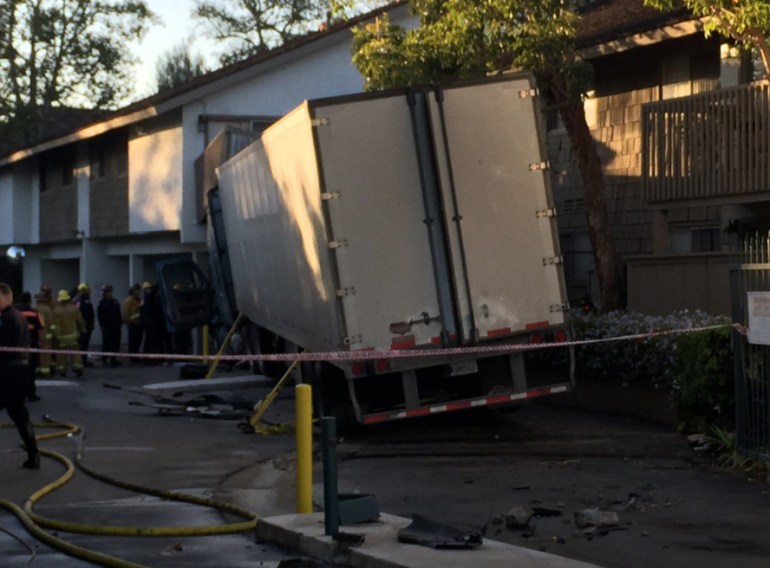 The driver of a big rig was injured after the truck crashed into an apartment building in Orange on Nov. 9, 2015. (Credit: Chip Yost/KTLA)