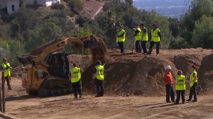 Los Angeles County coroner's workers dig in a canyon in Altadena on Nov. 4, 2015, three days after a human femur was found at the site. (Credit: KTLA)