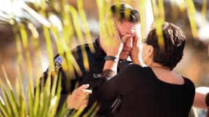 A Downey police officer is consoled after the body of slain Officer Ricardo Galvez was moved to the coroner's van on Nov. 19, 2015. (Credit: Al Seib / Los Angeles Times)