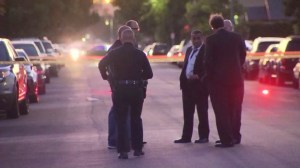 Investigators work outside a South L.A. residence where a body was found Nov. 10, 2015. (Credit: KTLA)
