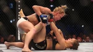 Holly Holm, top, upset Ronda Rousey at UFC 193 in Melbourne, Australia, on Saturday, Nov. 14, 2015. (Credit: Quinn Rooney/Getty Images)