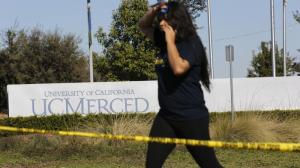 A UC Merced student walks past police tape to leave campus after stabbings on Nov. 4, 2015. (Credit: Michael Robinson Chávez / Los Angeles Times) 